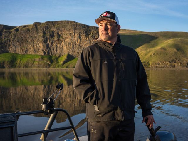 Portrait of Toby Wyatt standing on his boat on the Snake River