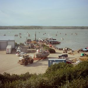 Harbor area, fishing boat being pulled away by tractor