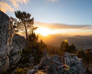 The sun rises over cliffs near Cape Town, South Africa
