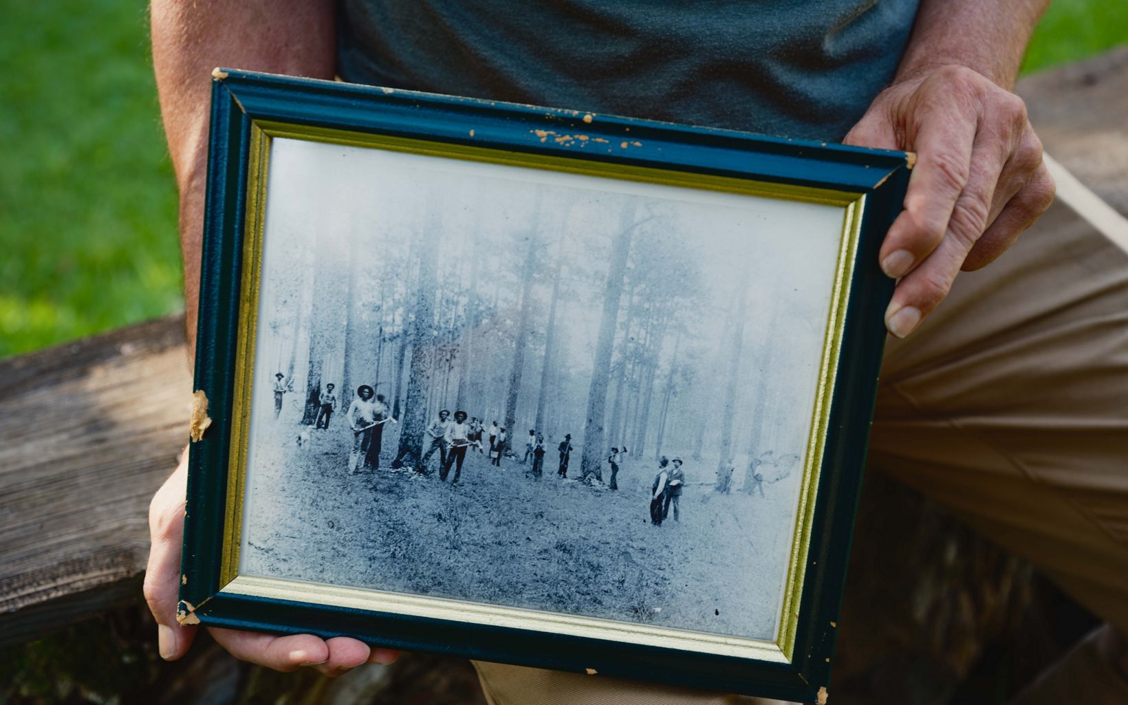 
                
                  Turpentine Plantation Jesse Wimberley holds a photograph of formerly enslaved people working on his ancestor's turpentine farm. Plantations such as this produced turpentine throughout the south.
                  © Andrew Kornylak
                
              