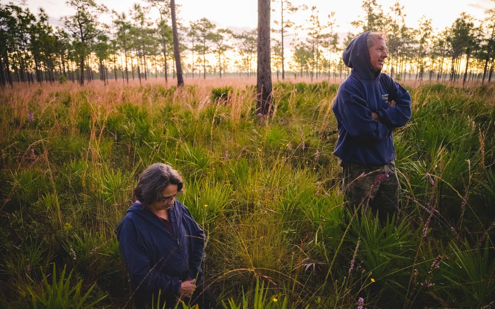 
                
                  Waiting Biologist Mike Keys and Beatriz "B" Pace-Aldana wait to capture a red-cockaded woodpecker in the early morning on the Disney Wilderness Preserve.
                  © Andrew Kornylak
                
              