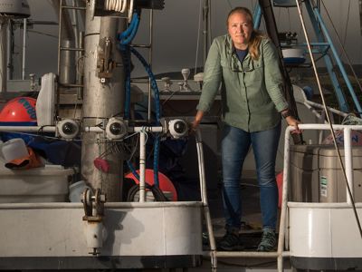 Kate Kauer stands by cameras installed on a fishing boat