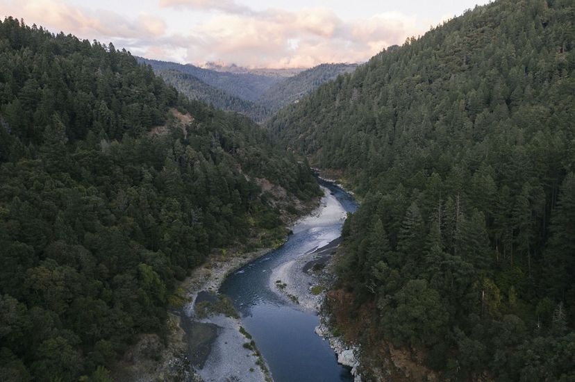 Aerial view of the Klamath River, surrounded by forested land.