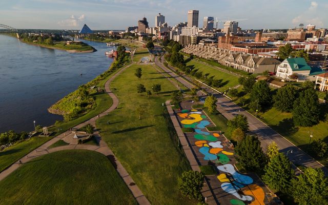 An aerial view of a park with colorful pavement in Memphis next to the Mississippi River.