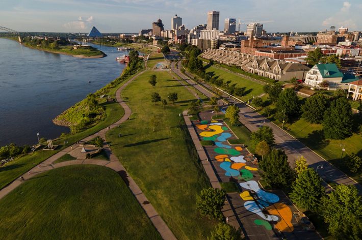 An aerial view of a park with colorful pavement in Memphis next to the Mississippi River.