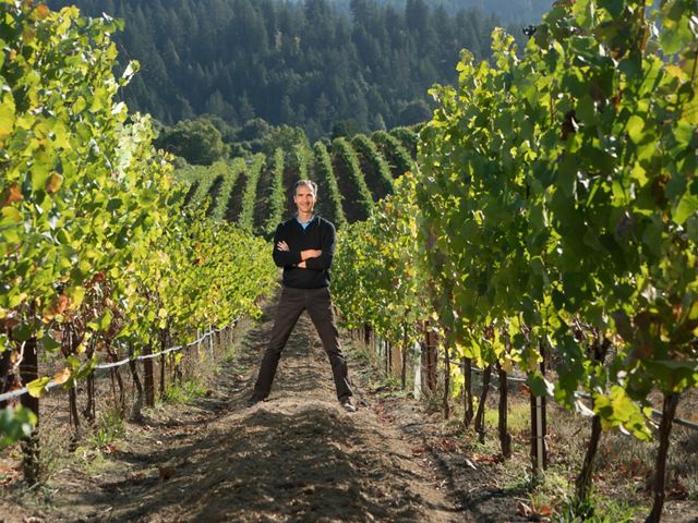 California vintner Garnaud Weyrich stands between rows of grapes at his vineyard.
