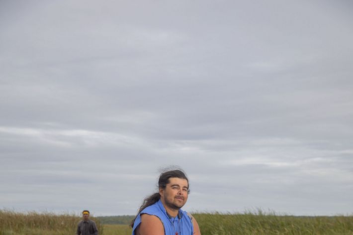A man sits on a boulder.