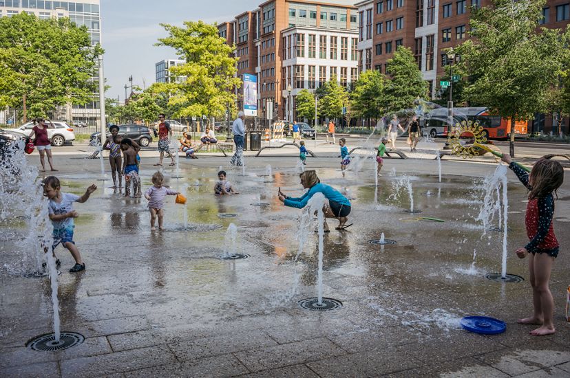 Children play on a splash pad in Washington, DC.