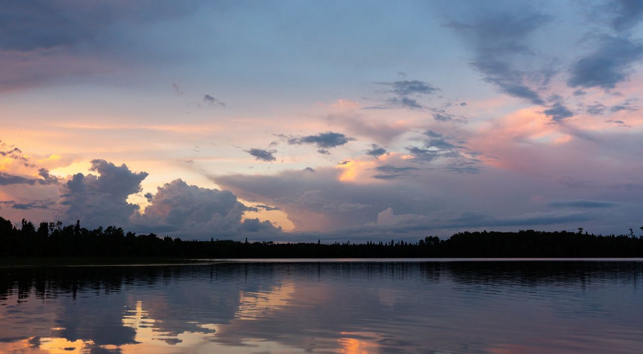 The sun sets over a lake.