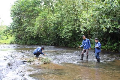 Three people in shallow water.