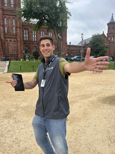A face-to-face fundraiser strikes a pose for a photo holding an iPad. 
