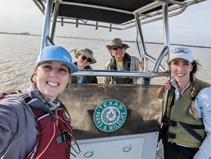 scientists on a boat smile for the camera.