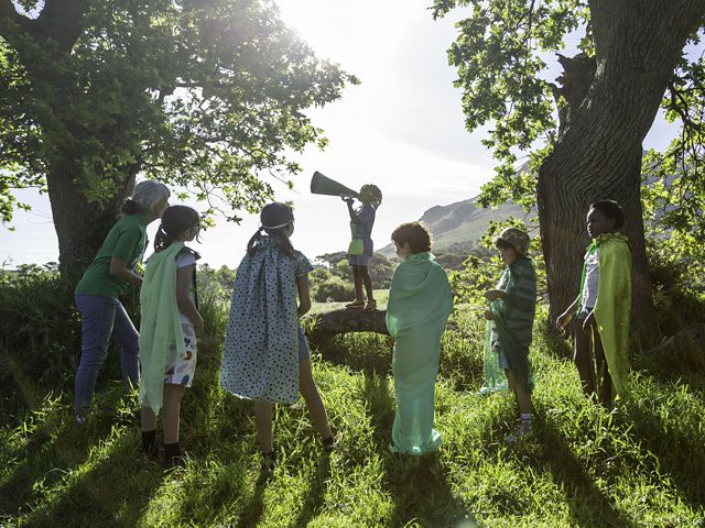 kids gathered under a tree