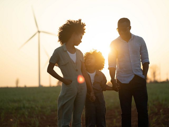 Family in front of wind turbines.