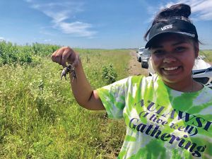 Girl holding crawfish.