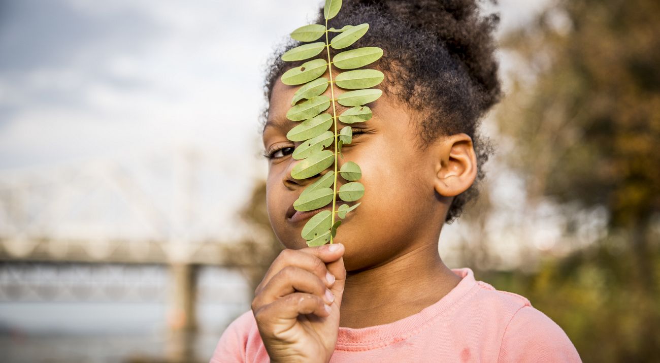 girl holding leaf.