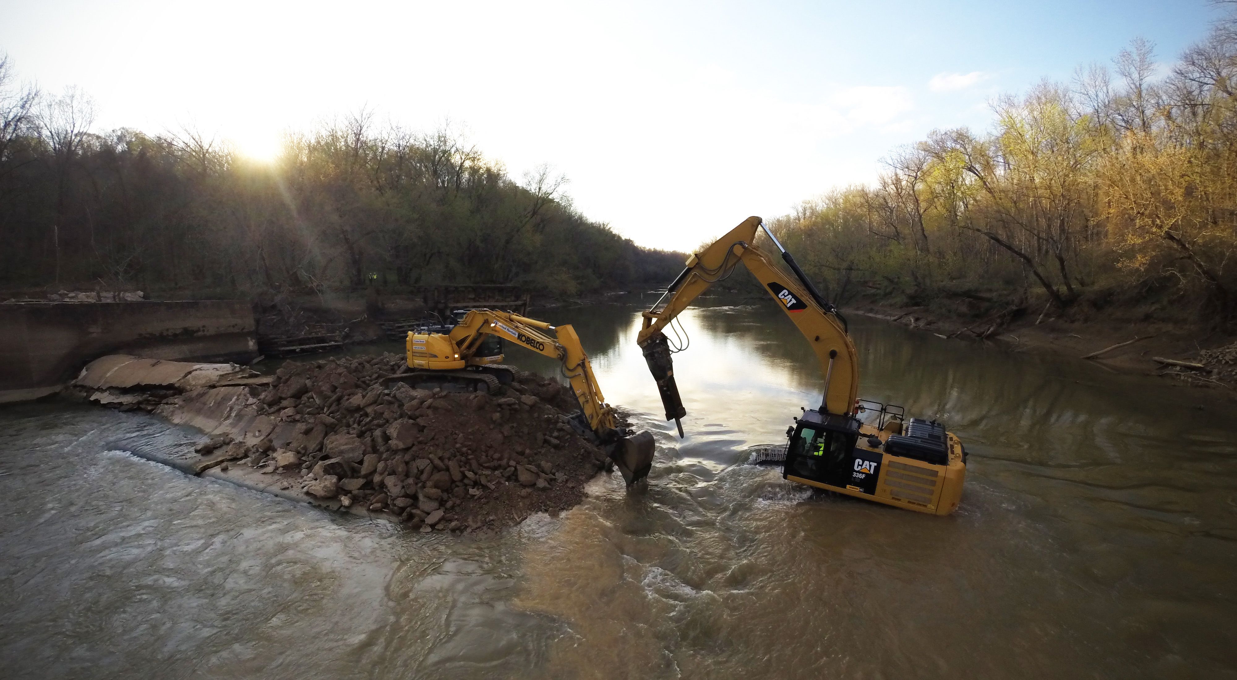 A dam is removed by heavy equipment.