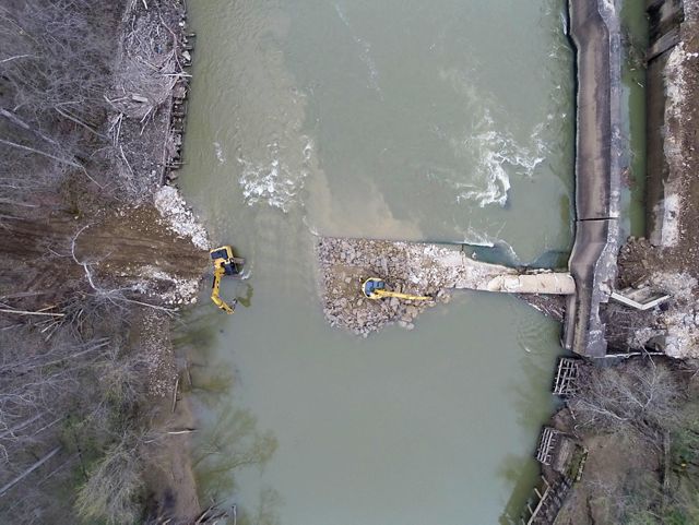 Aerial photo looking down at a dam removal project underway in the Green River in Kentucky, with heavy equipment working to remove the dam and allow the river to flow freely.