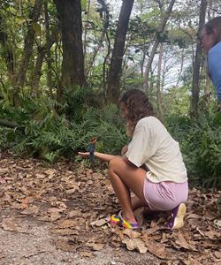 A bird perches on the arm of a volunteer.