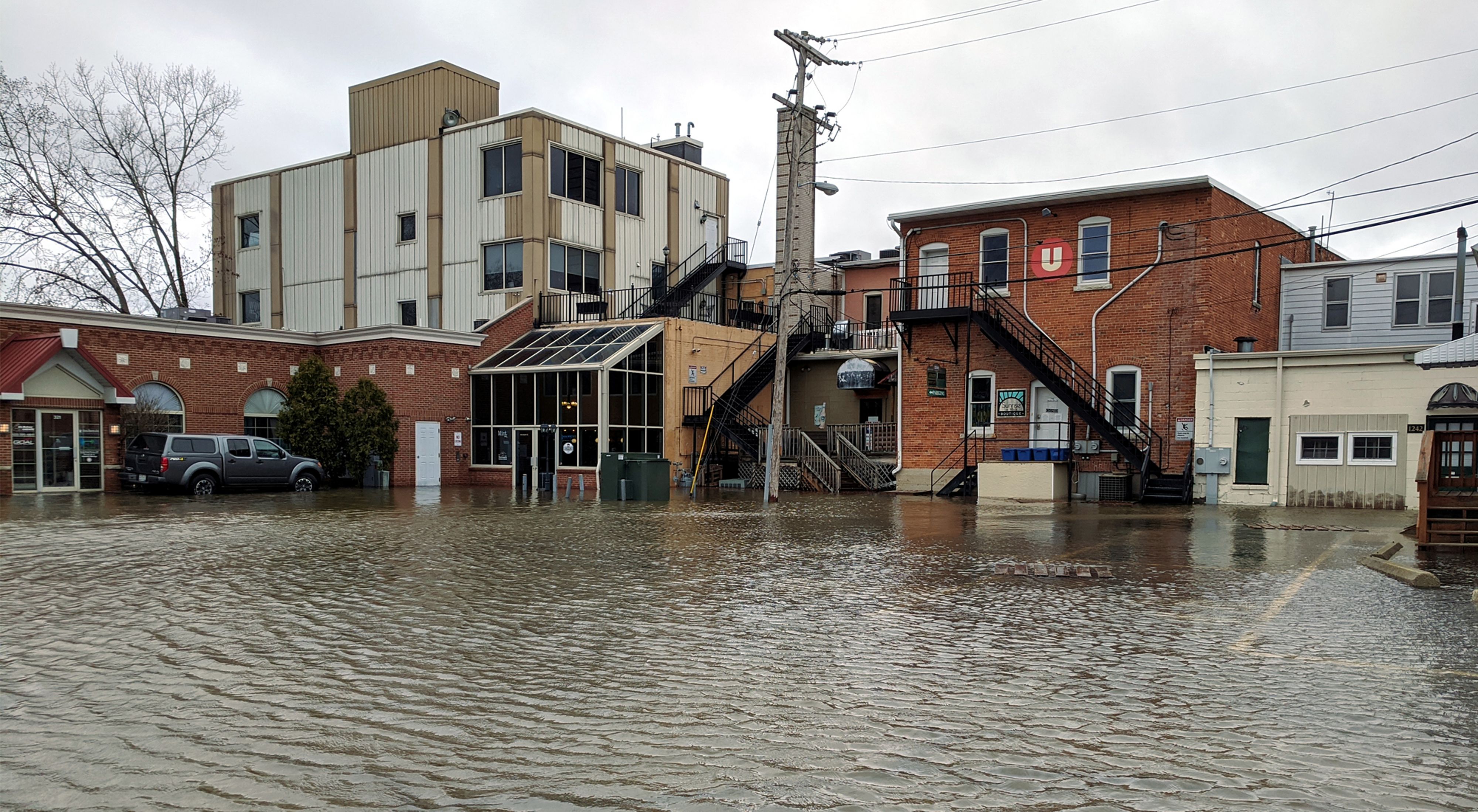 Several buildings in Green Bay, Wisconsin with floodwaters coming up to the entrances.