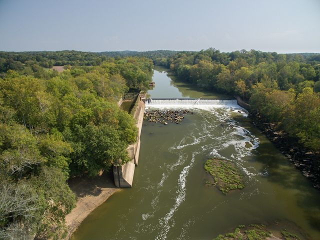 A river with a large dam in it.