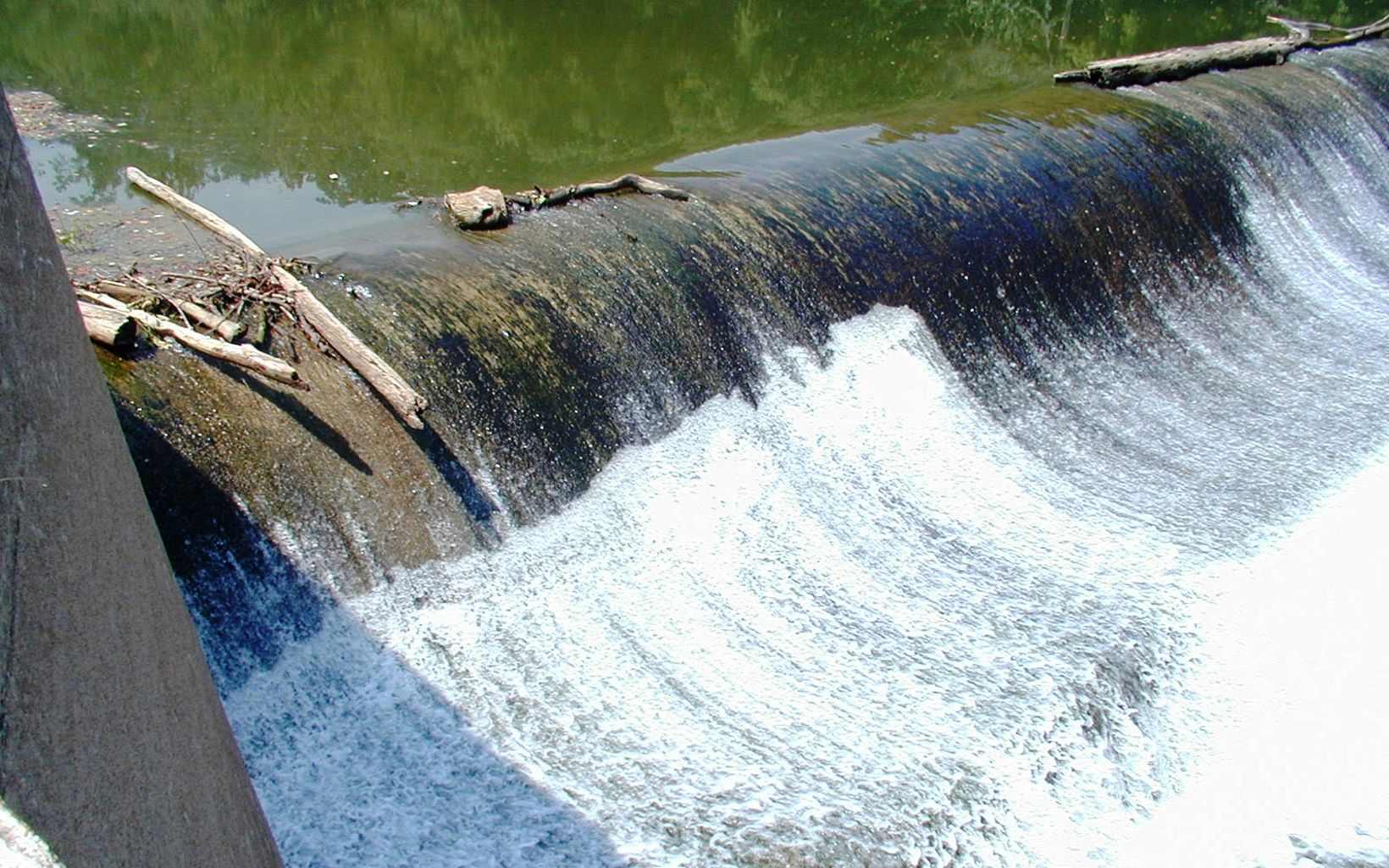 An aging dam shows signs of leakage.
