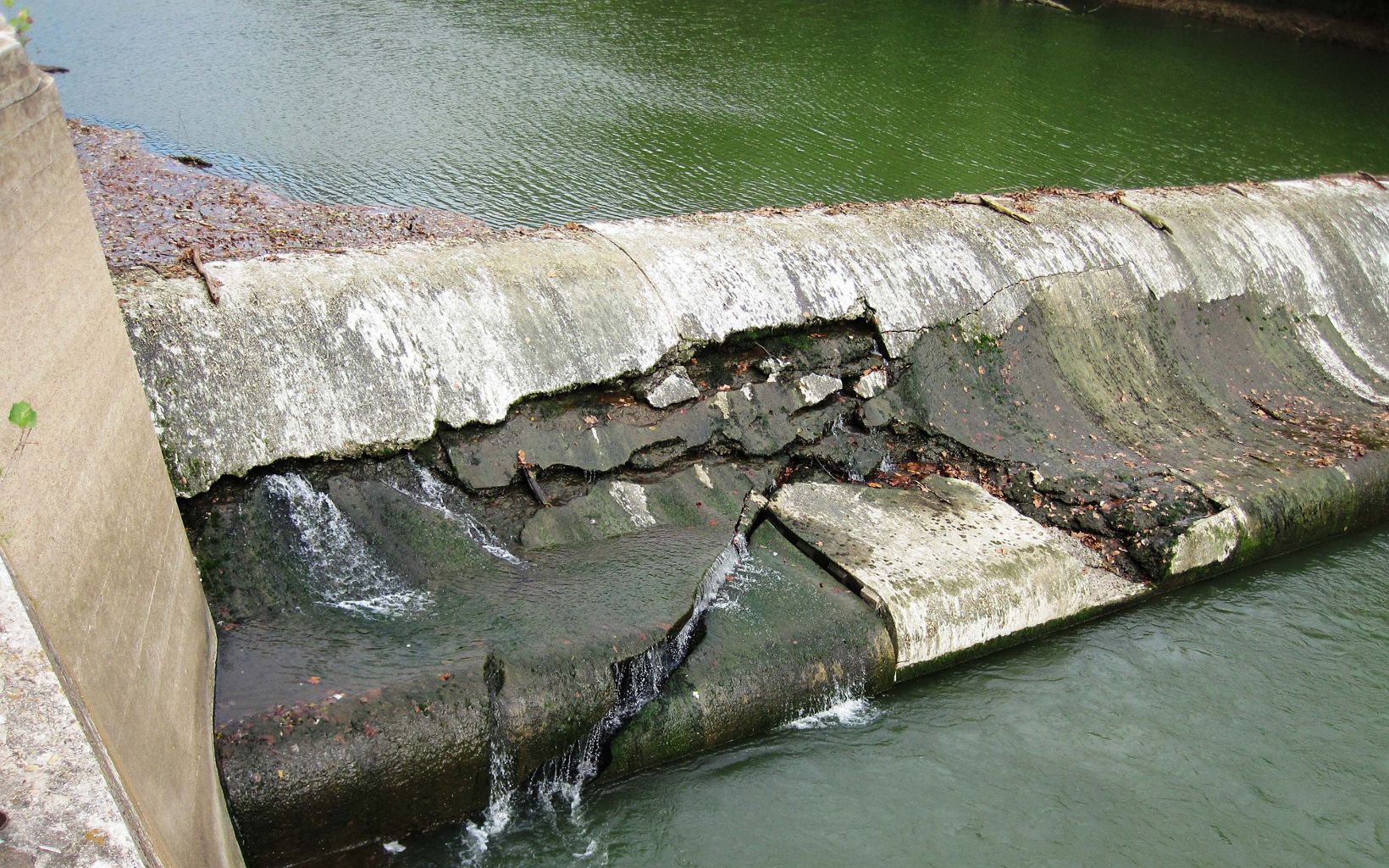 An aging dam starts to show signs of stress. 