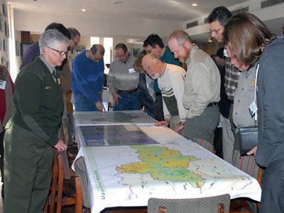 People gather around a map.