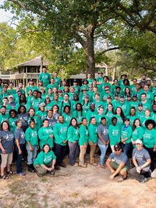 A large group of crew members in green shirts.