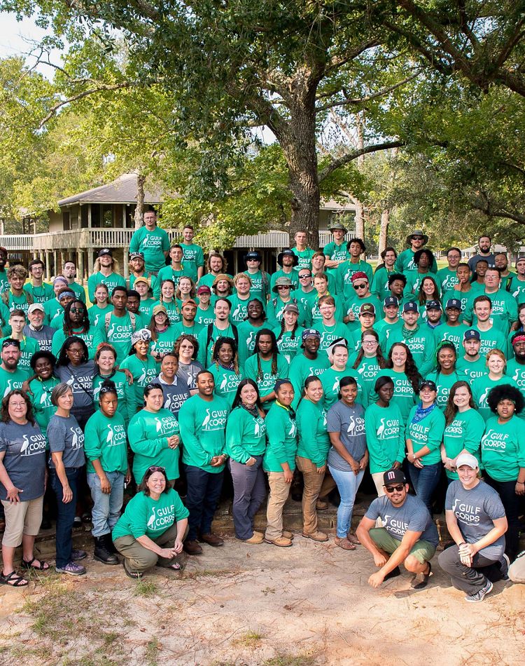 A large group of crew members in green shirts.