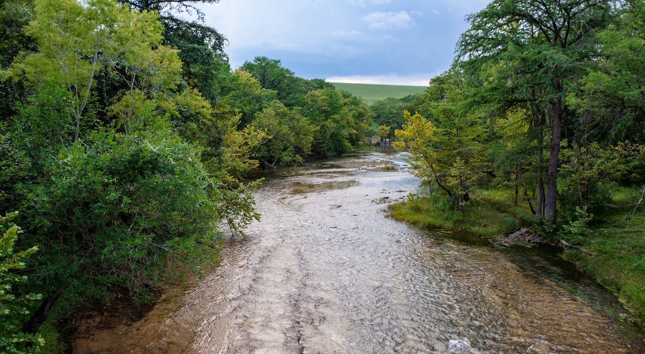 River winds through a tree-lined valley.
