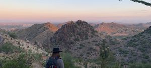 Hiker in a rugged desert landscape.