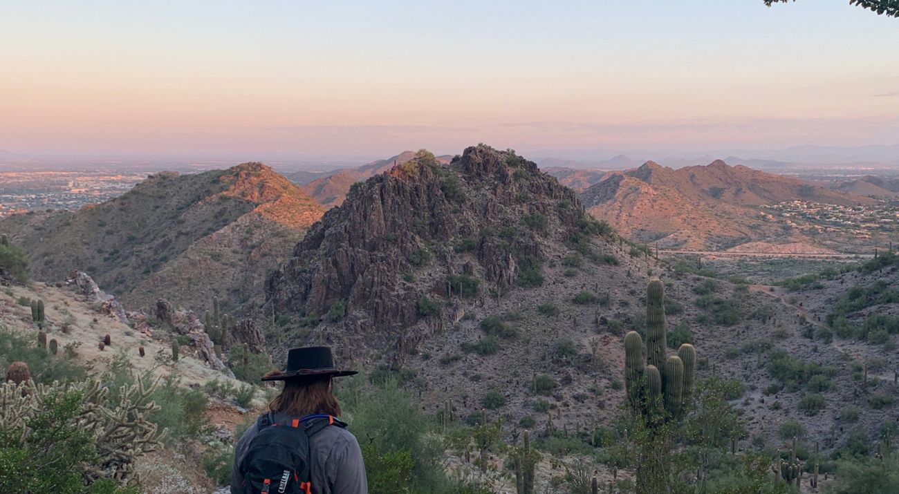Hiker in a rugged desert landscape.
