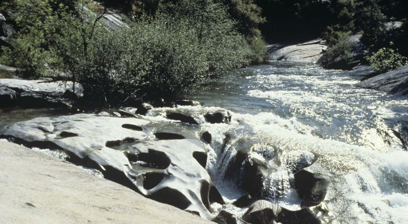 Water cascading over boulders in a river.