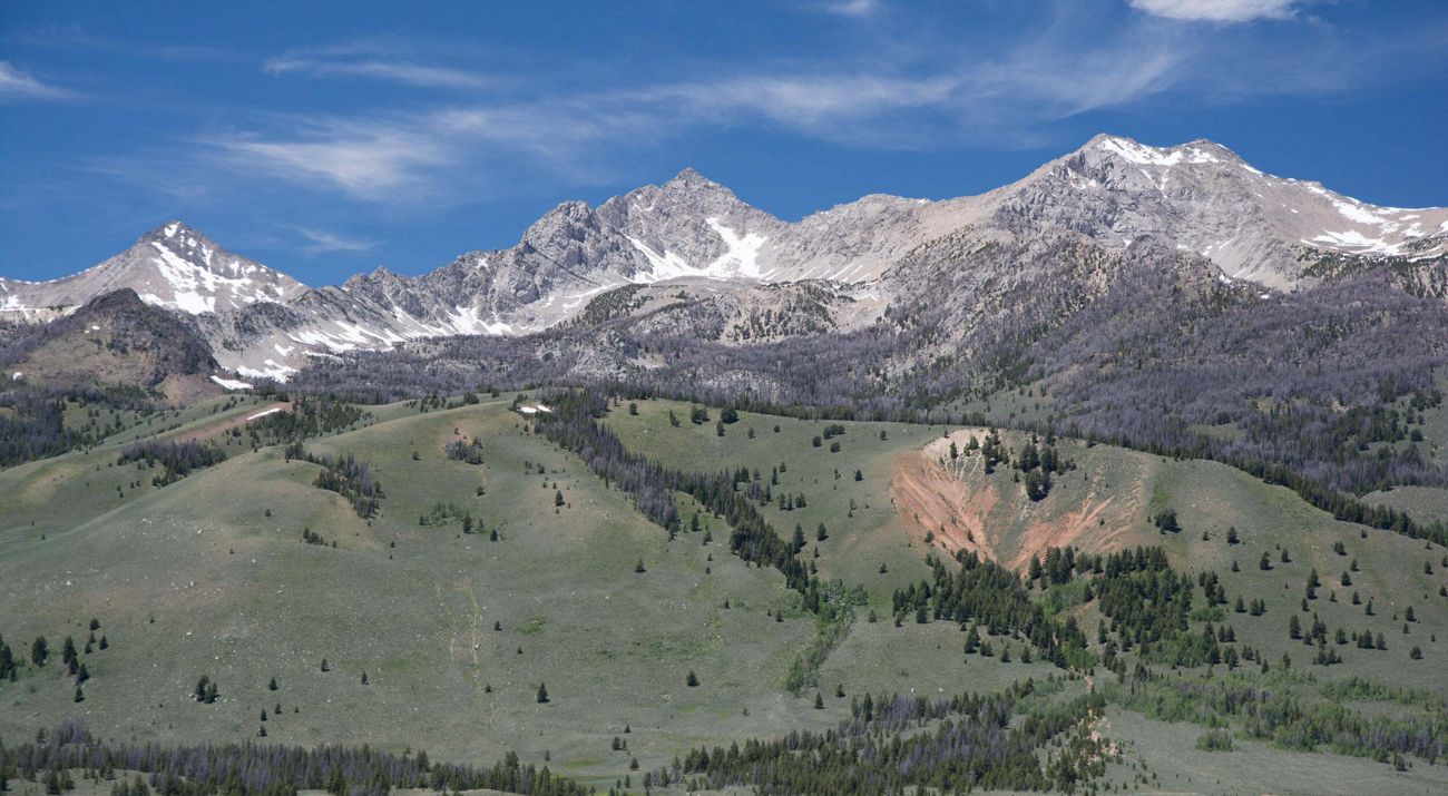 View of rugged mountains under blue sky.