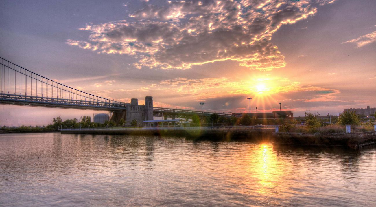 A bridge crossing a river at sunrise.