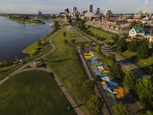 Aerial view of a city park alongside a river.