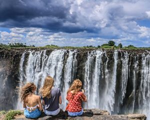 Tres personas frente a las cataratas Victoria en el sur de África