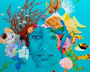 A bright turquoise mural of a woman's face with sea creatures as hair.