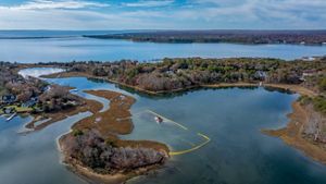 Aerial view of a boat depositing shells into a section of Hamblin Pond in off Seconsett Island. 