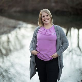 Portrait of Heidi Mehl standing outside in front of a river.