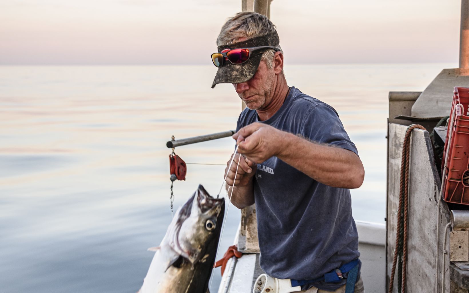 Tyler Bond catches fish with a jigging machine on Safe Haven.