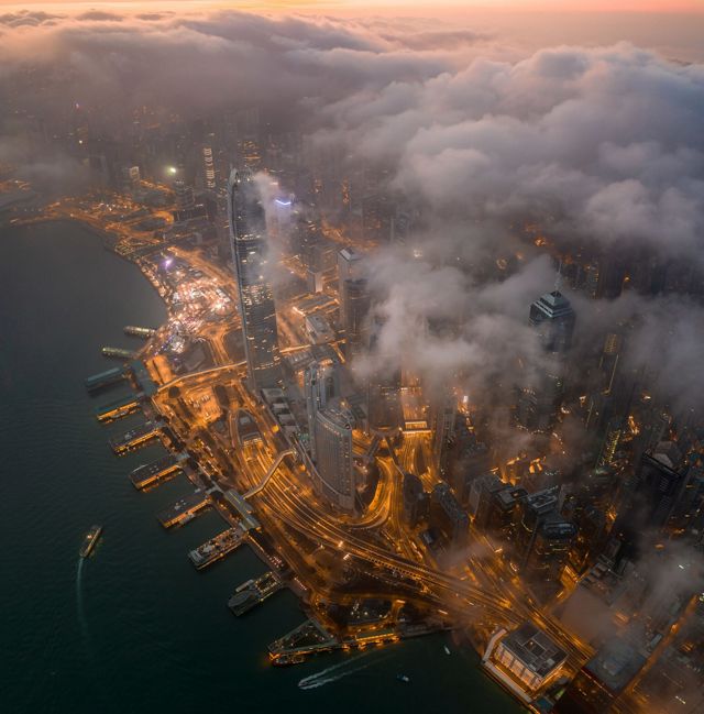 The view of the world famous Victoria Harbour under the clouds in the early morning.