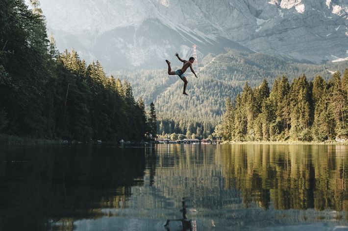 A jump into the iconic lake Eibsee in southern Germany on a hot summer day.