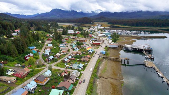 Aerial view of colorful houses on the shore of a body of water.
