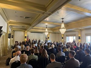 Audience watches panel discussion.