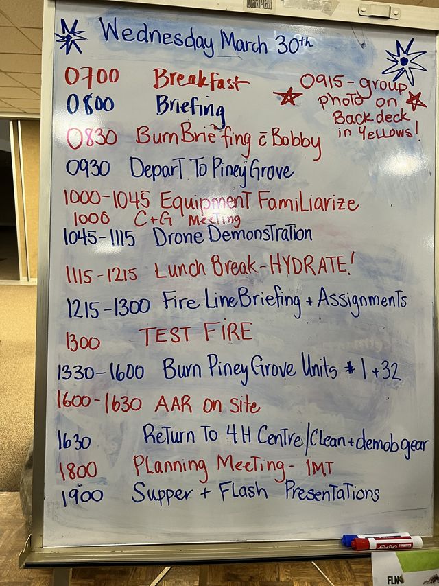 A white board showing the WTREX training schedule for Wednesday, March 30 2022 beginning with breakfast at 7:00 am and ending with dinner and presentations at 7:00 pm.