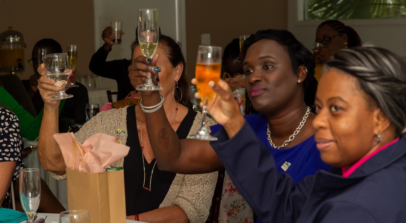 a celebration with people toasting their glasses.
