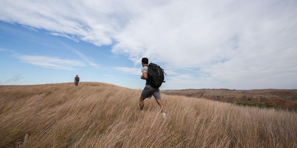 Hikers walking along a ridge at the Four Canyon Preserve.