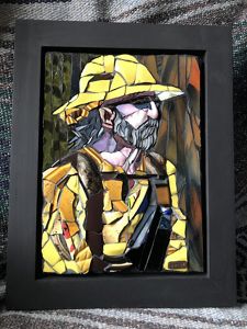 A tile mosaic work of art in the shape of a person wearing a fire suit.